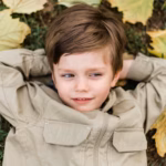 top-view-little-boy-staying-grass_23-2148619432